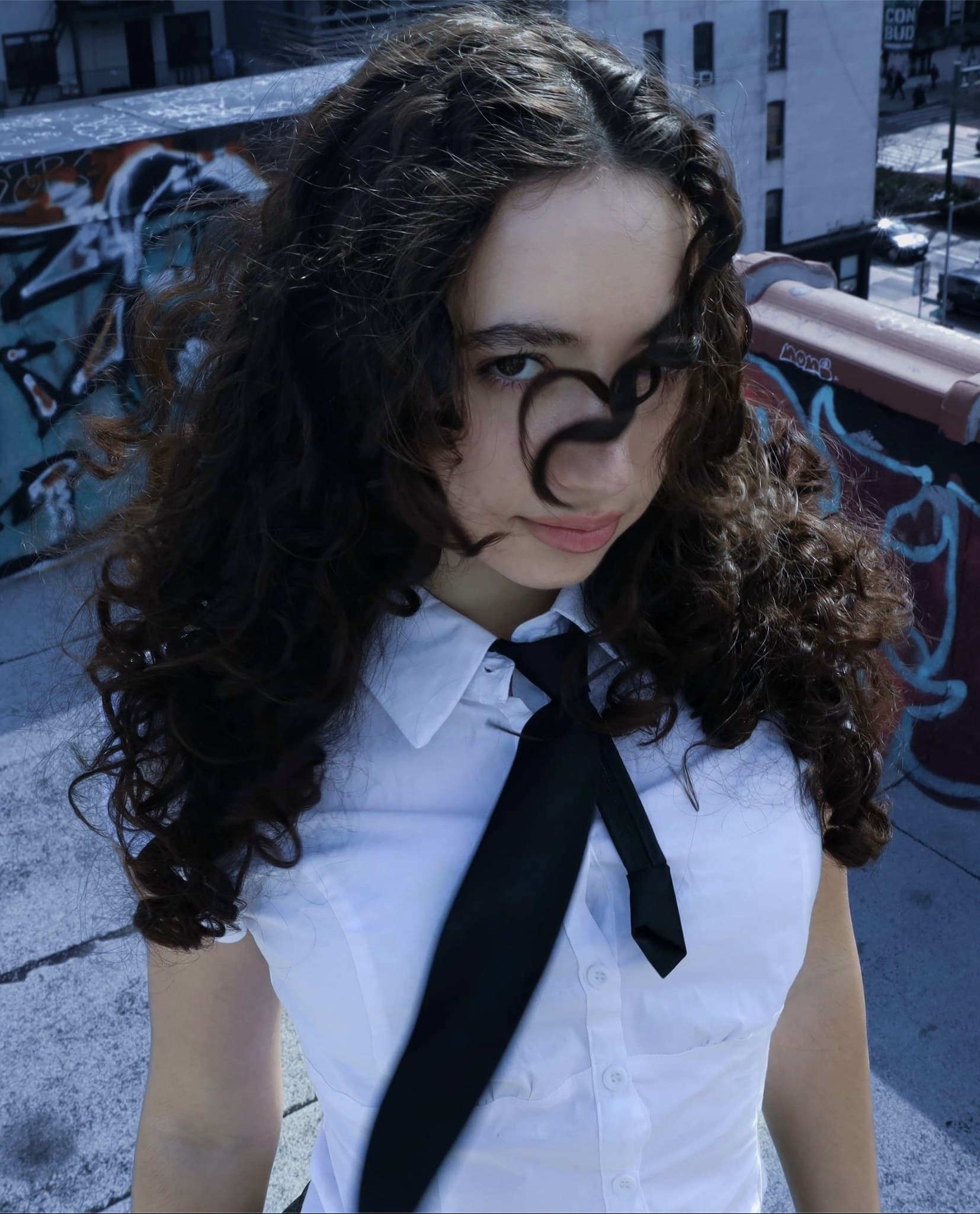 Catherine Bazizi, rooftop portrait in white shirt and black tie